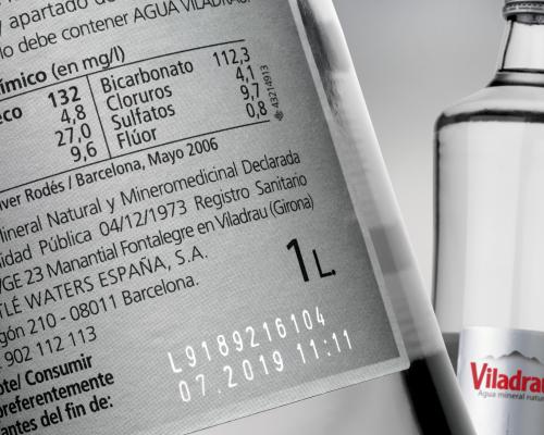 Laser coding on glass beverage bottles, providing permanent and precise markings for branding and traceability.