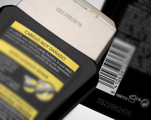 Laser coding on perfume bottles for clear and durable product labeling.