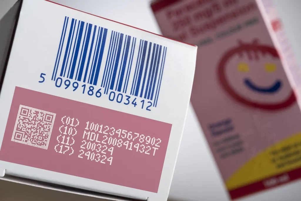 Precise laser marking on cardboard boxes for product identification.